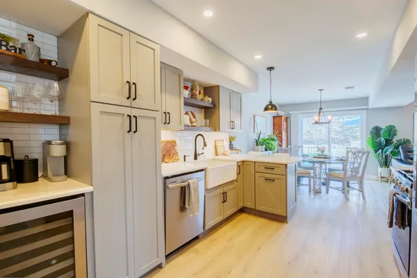a kitchen with white cabinets and stainless steel appliances