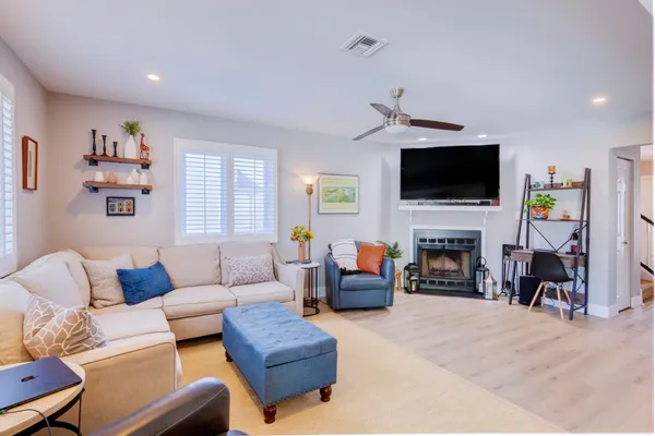 a living room with furniture a fireplace and a flat screen tv