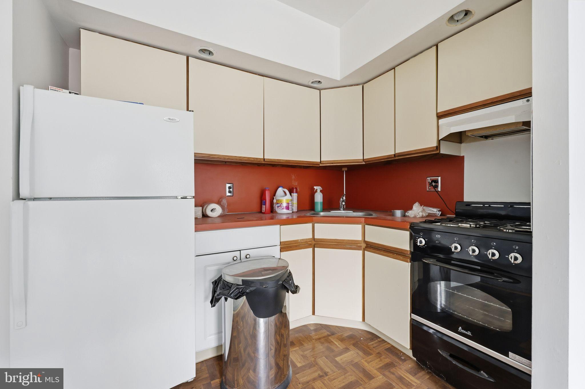 1713 South Street Philadelphia, PA 19146 - Photo 14 of 35 a kitchen with stainless steel appliances a refrigerator and a stove top oven