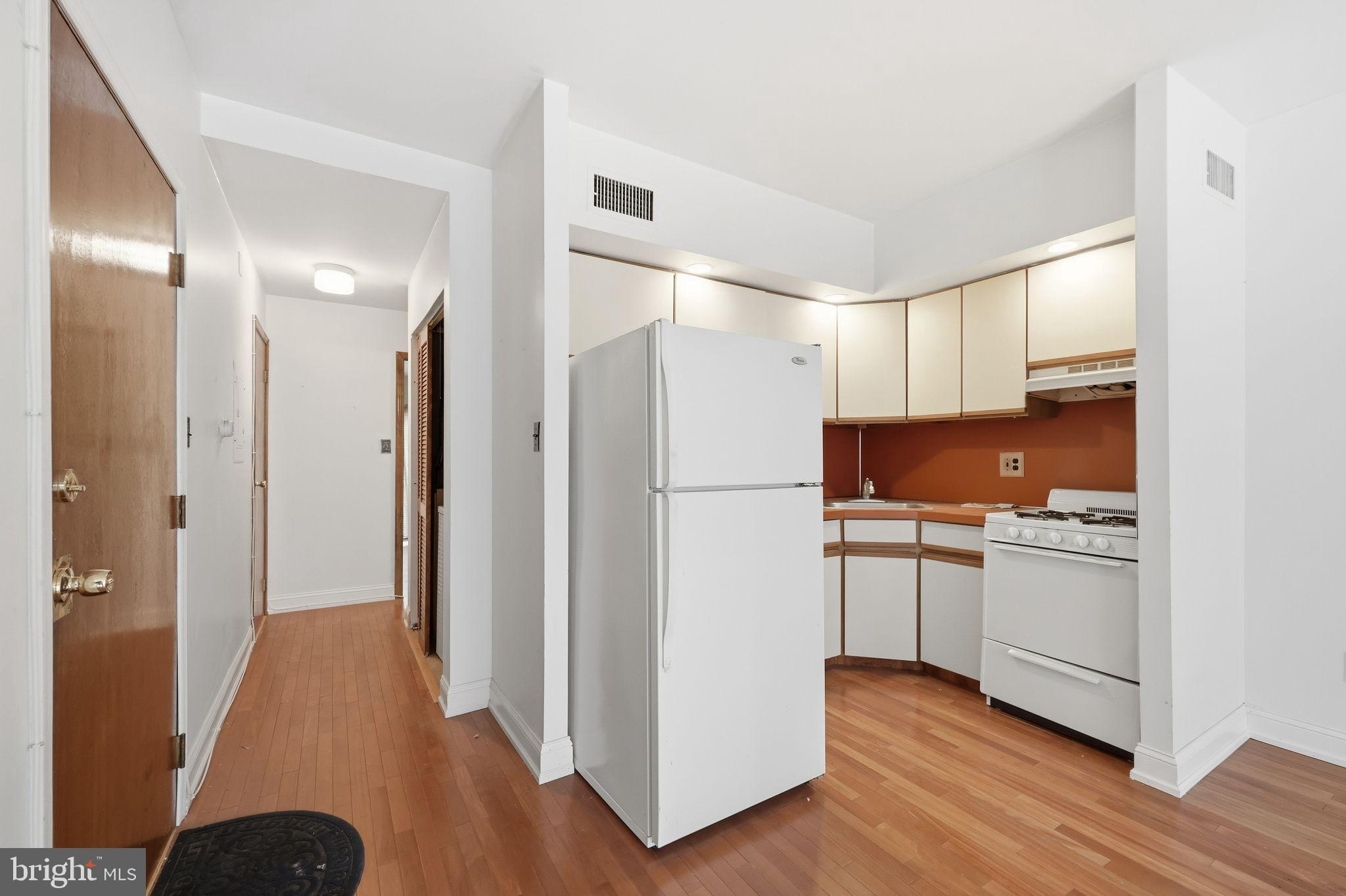 1713 South Street Philadelphia, PA 19146 - Photo 16 of 35 a kitchen with a refrigerator a sink and a stove top oven