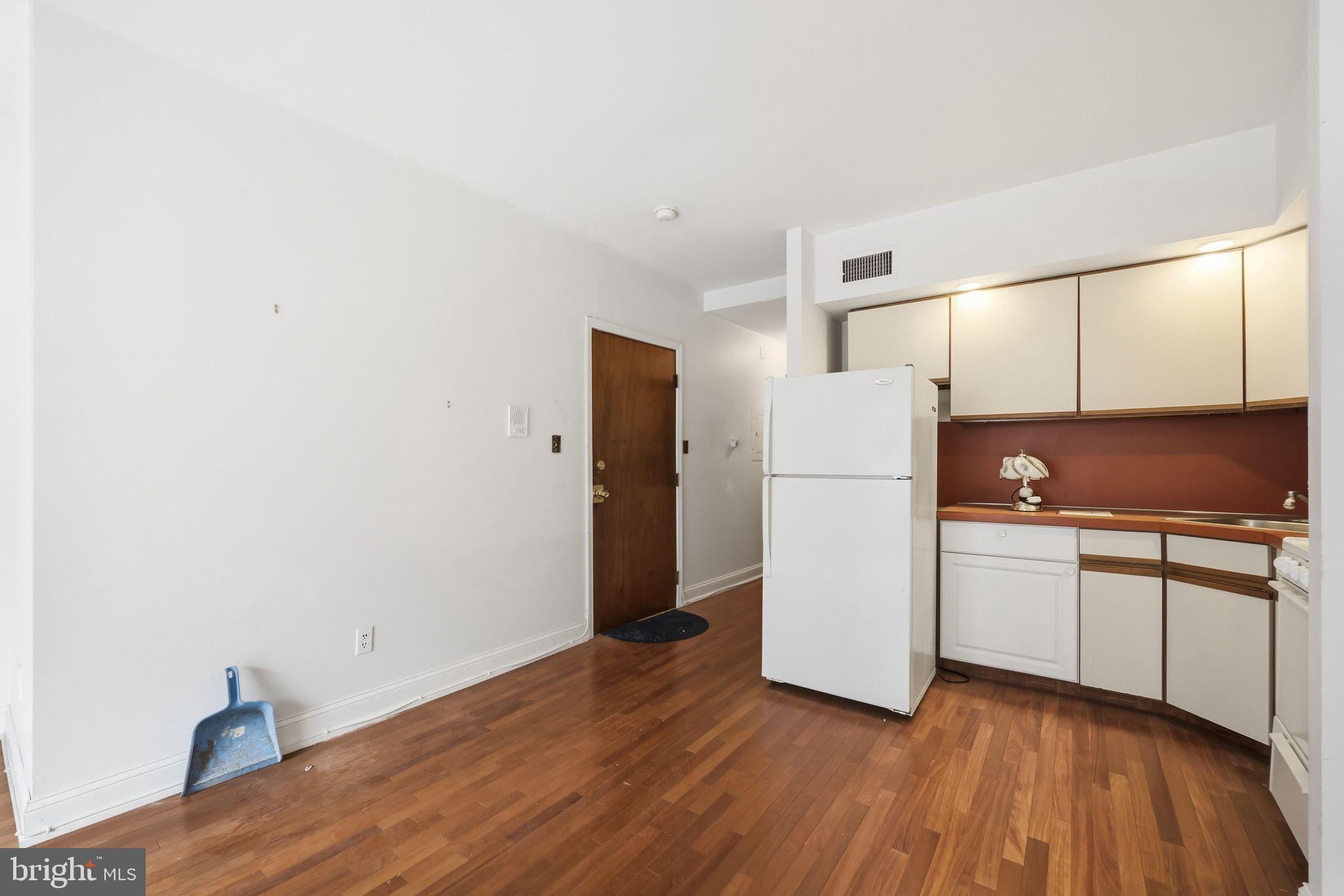 1713 South Street Philadelphia, PA 19146 - Photo 31 of 35 a kitchen with a refrigerator and a stove top oven