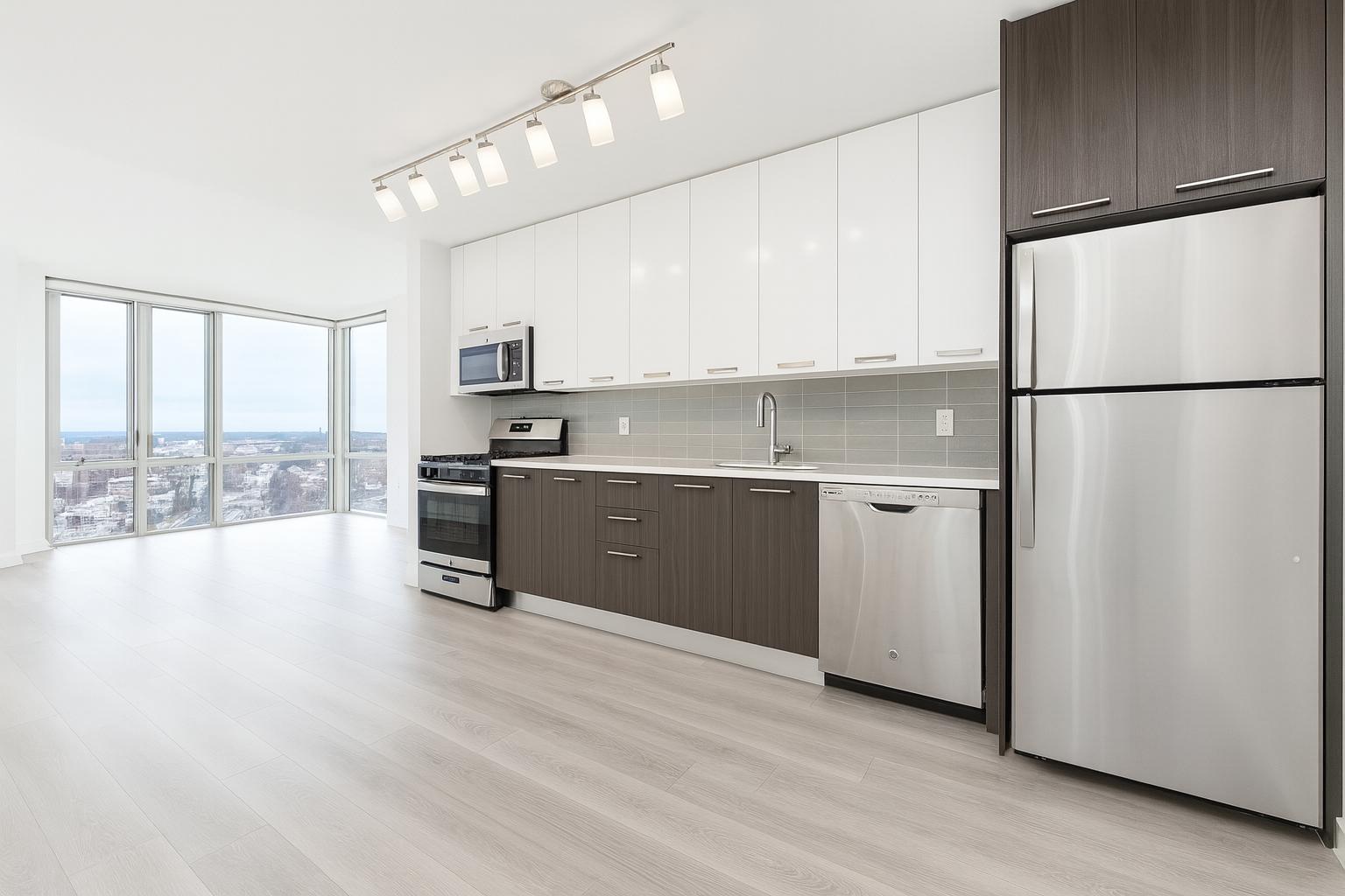 1524 Sheepshead Bay Road, Unit 17D Brooklyn, NY 11235 - Photo 4 of 24 a kitchen with stainless steel appliances a refrigerator sink and cabinets