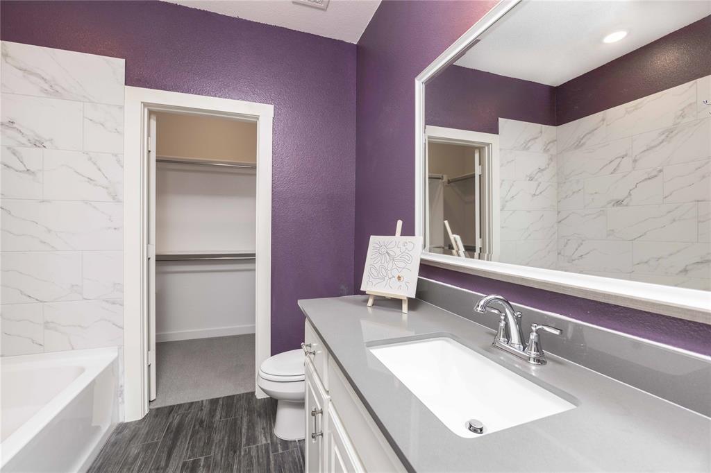 631 Cobblestone Lane Irving, TX 75039 - Photo 18 of 32 a bathroom with a granite countertop sink toilet and shower