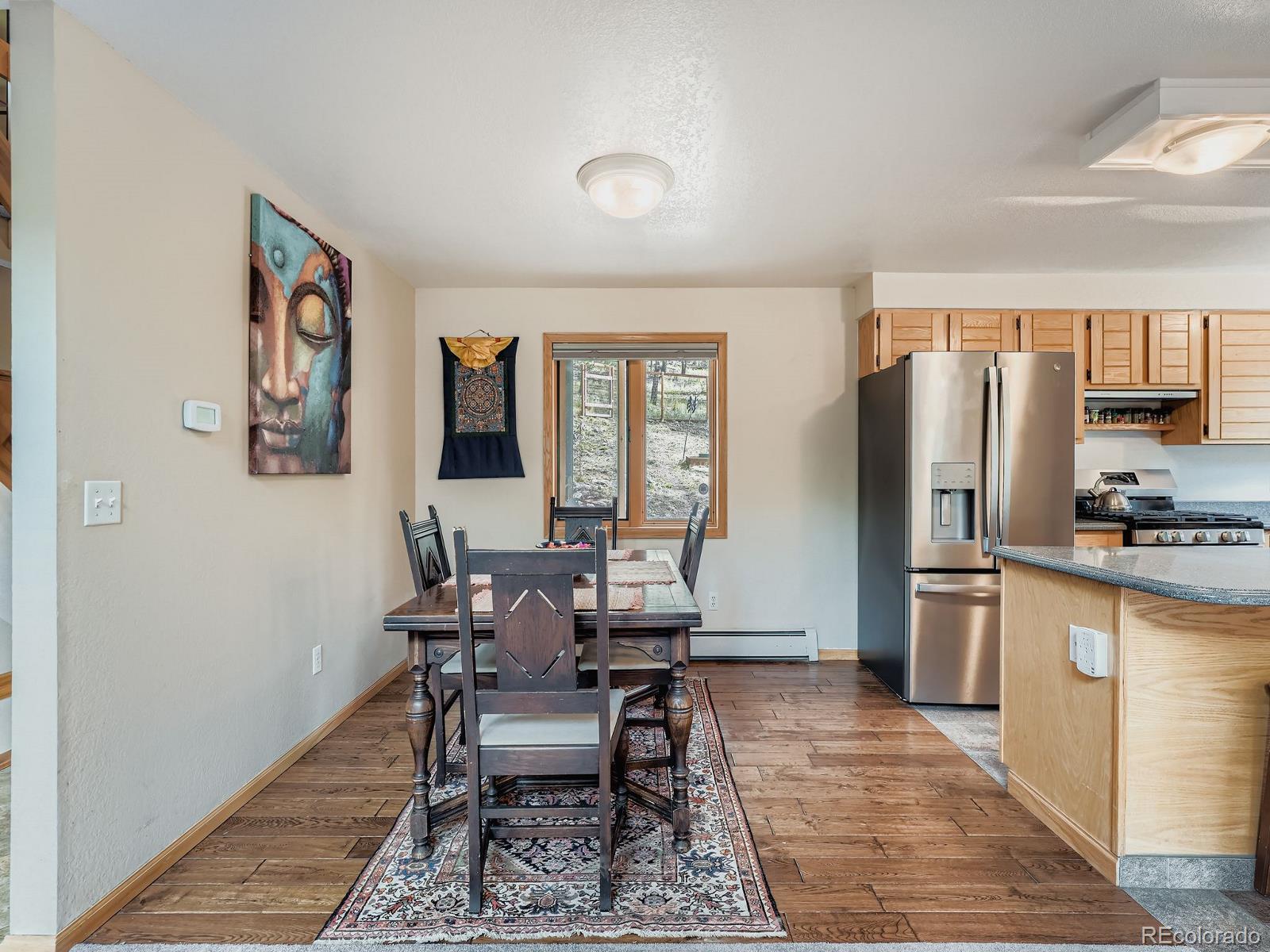 425 Patty Drive Evergreen, CO 80439 - Photo 11 of 43 a view of a dining room with furniture window and wooden floor