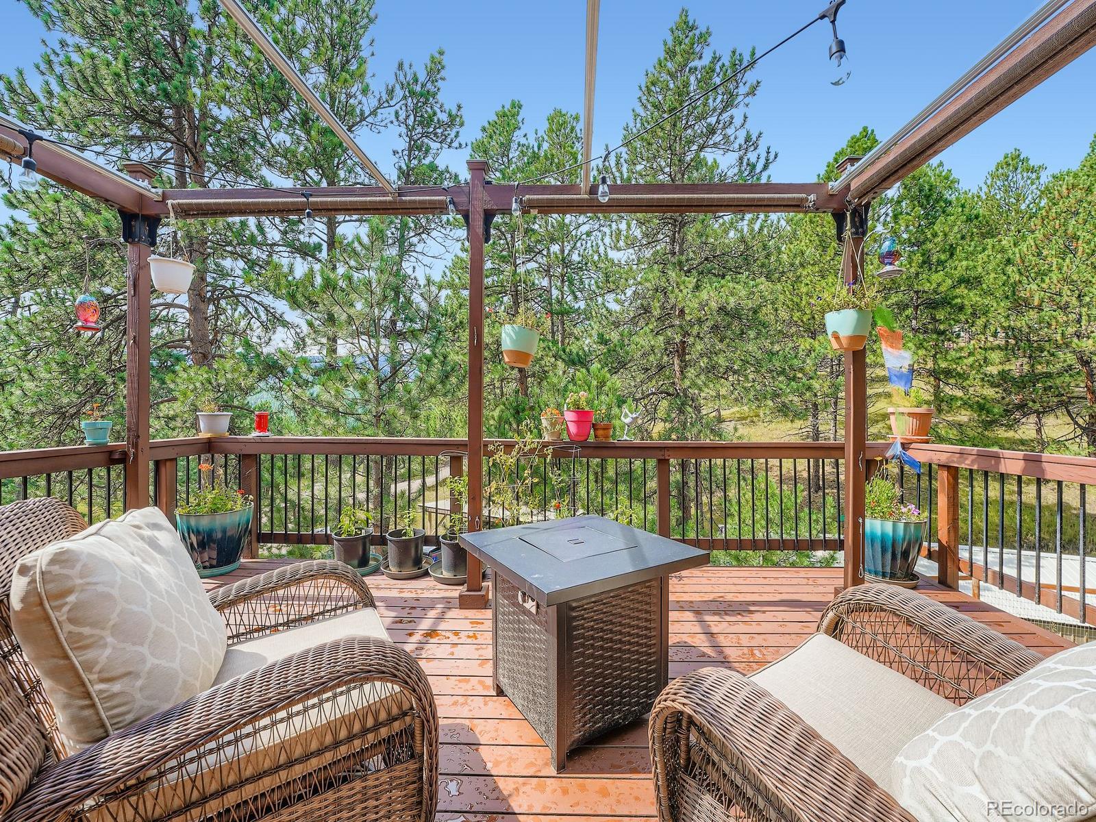 425 Patty Drive Evergreen, CO 80439 - Photo 13 of 43 a balcony with furniture and wooden floor