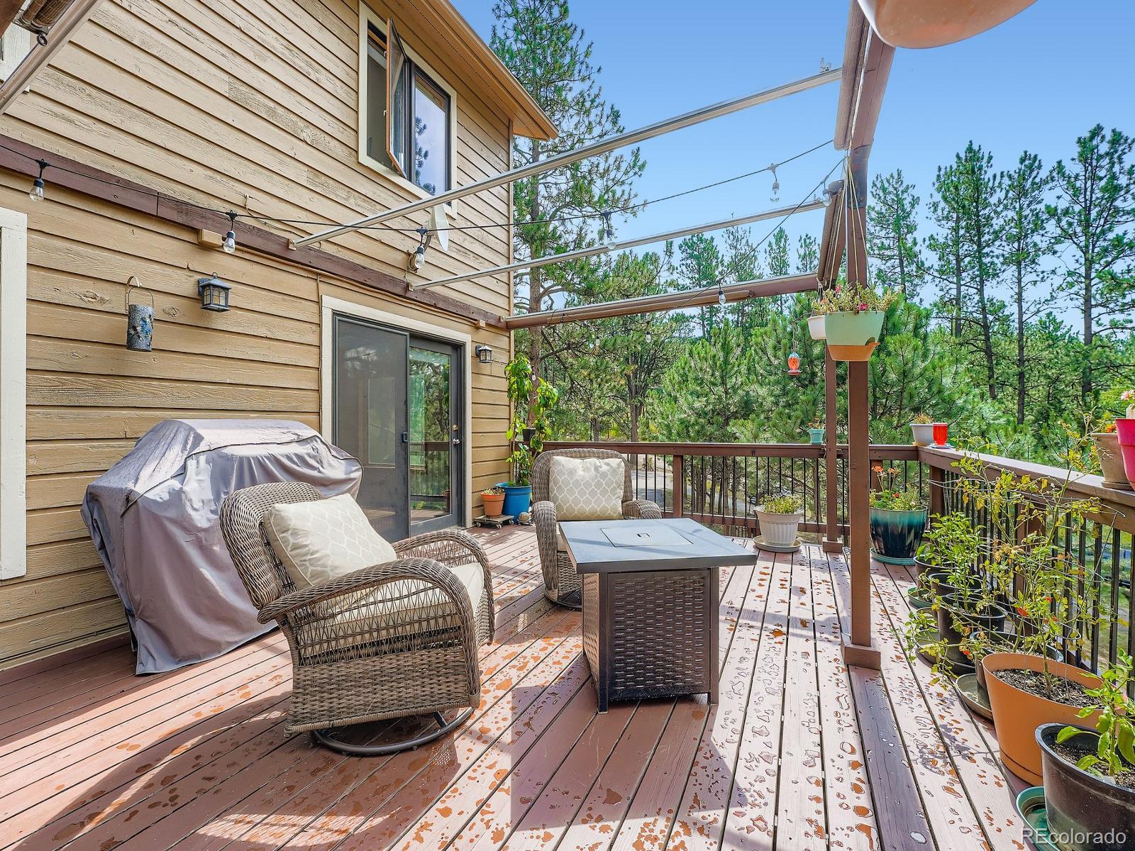 425 Patty Drive Evergreen, CO 80439 - Photo 14 of 43 a view of balcony with furniture and wooden floor