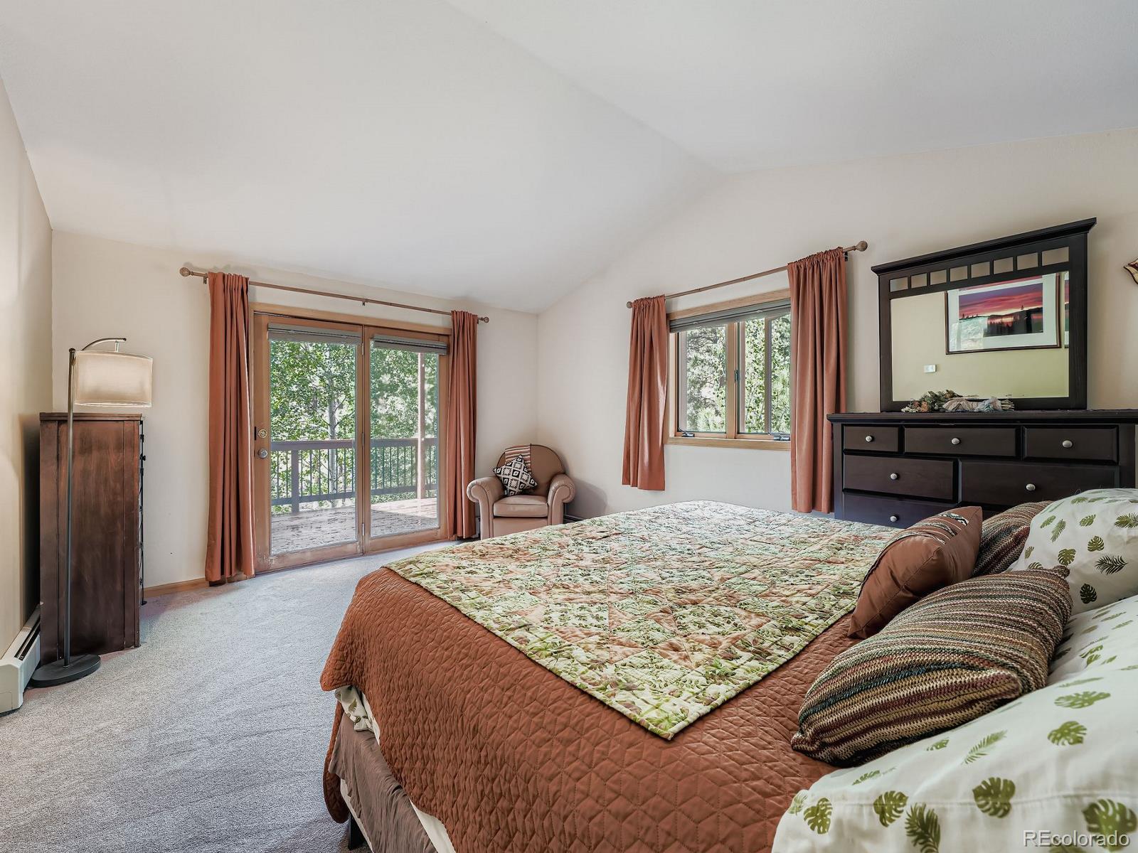 425 Patty Drive Evergreen, CO 80439 - Photo 15 of 43 a bedroom with a large bed and a window