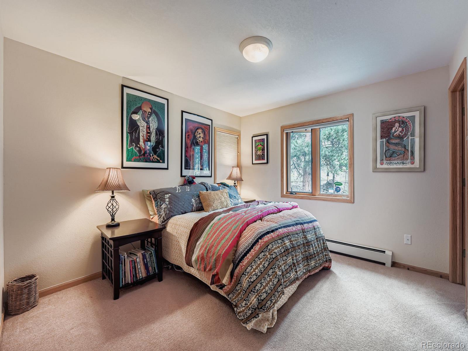 425 Patty Drive Evergreen, CO 80439 - Photo 21 of 43 a bedroom with a bed and a window