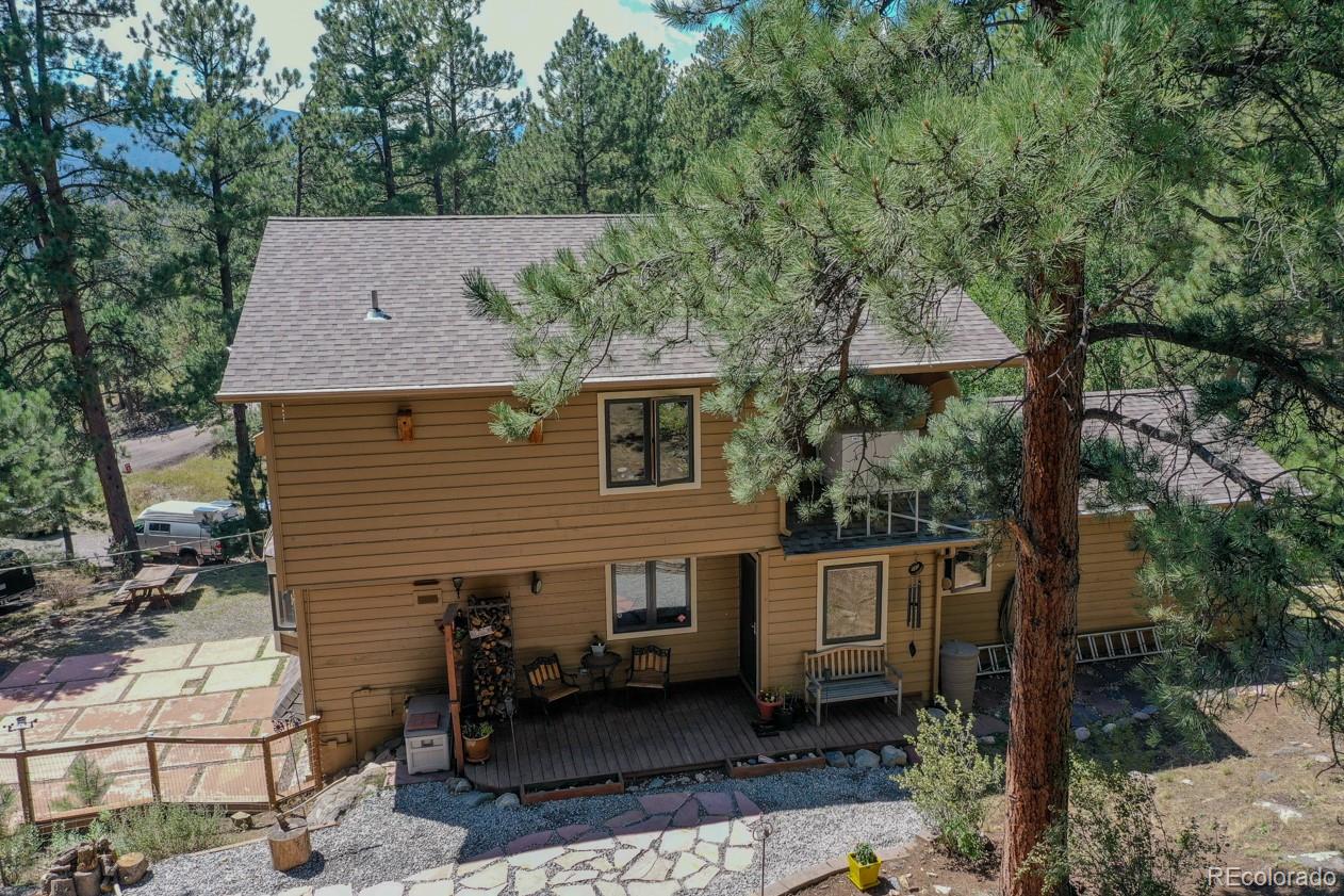 425 Patty Drive Evergreen, CO 80439 - Photo 36 of 43 a aerial view of a house with a yard balcony and furniture