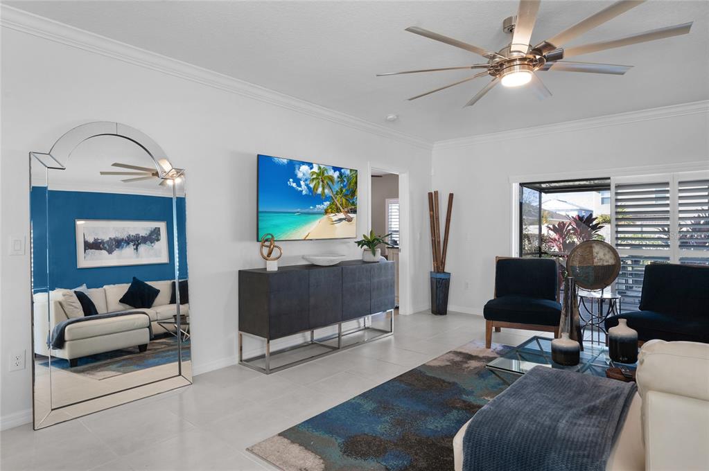 6236 Springmont Loop Palmetto, FL 34221 - Photo 12 of 55 a living room with furniture a flat screen tv and a fireplace