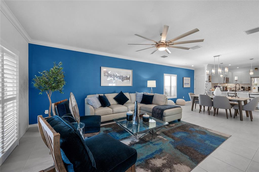 6236 Springmont Loop Palmetto, FL 34221 - Photo 14 of 55 a living room with furniture potted plant and a chandelier