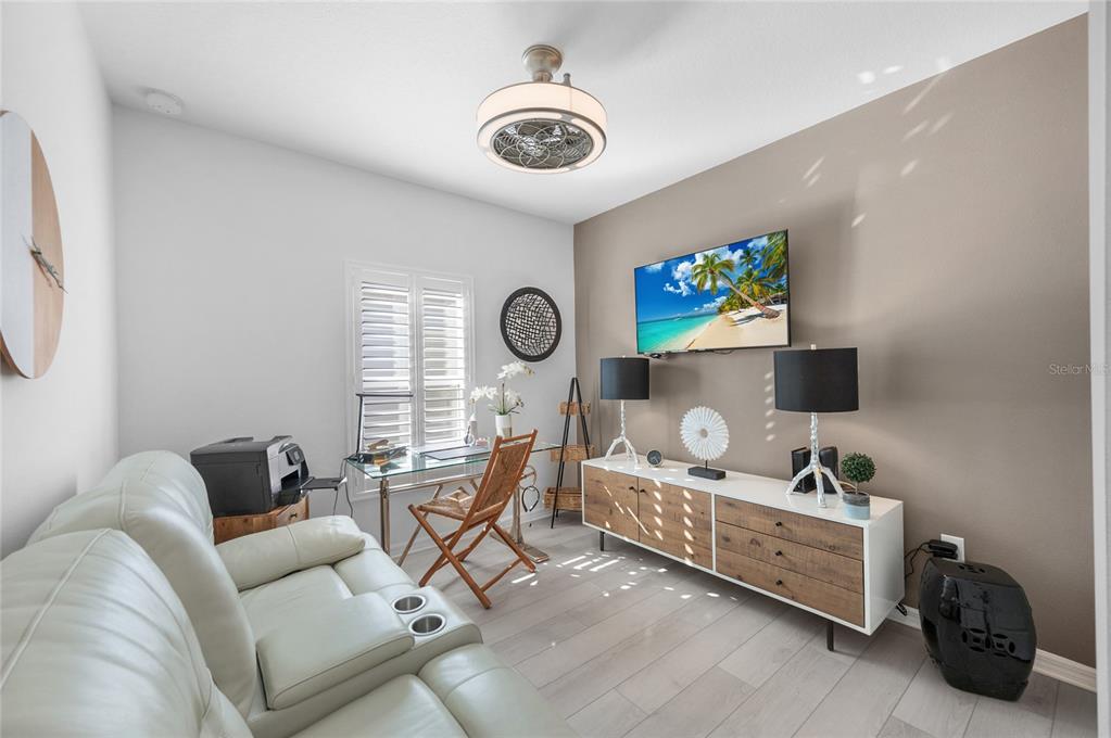 6236 Springmont Loop Palmetto, FL 34221 - Photo 21 of 55 a living room with furniture and a flat screen tv