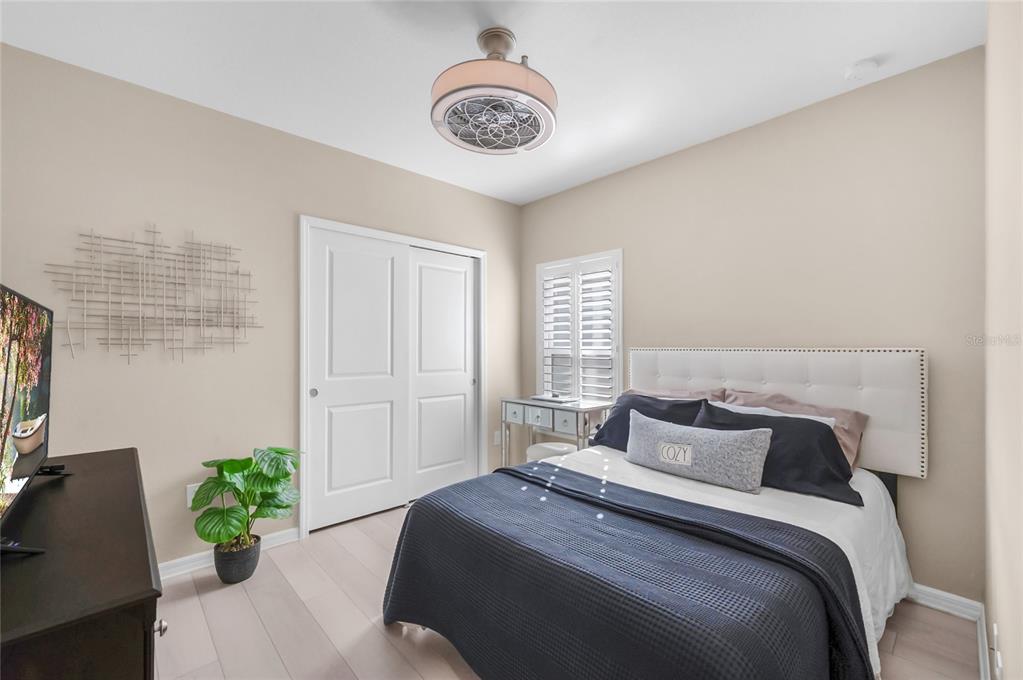 6236 Springmont Loop Palmetto, FL 34221 - Photo 23 of 55 a bedroom with a bed and a chandelier