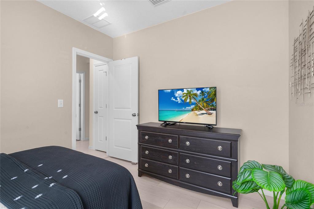 6236 Springmont Loop Palmetto, FL 34221 - Photo 24 of 55 a bedroom with a bed and a television