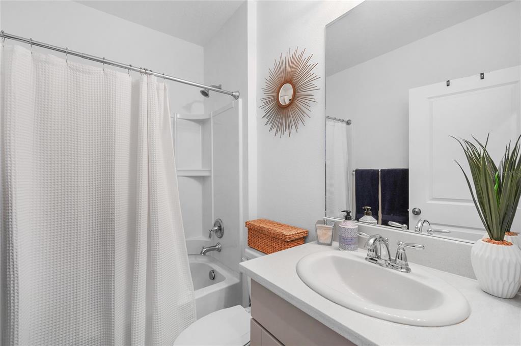 6236 Springmont Loop Palmetto, FL 34221 - Photo 25 of 55 a bathroom with a sink a toilet and a mirror