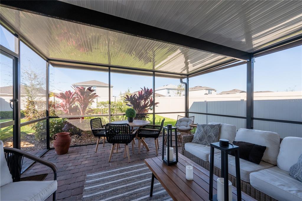 6236 Springmont Loop Palmetto, FL 34221 - Photo 29 of 55 a living room with furniture and floor to ceiling windows