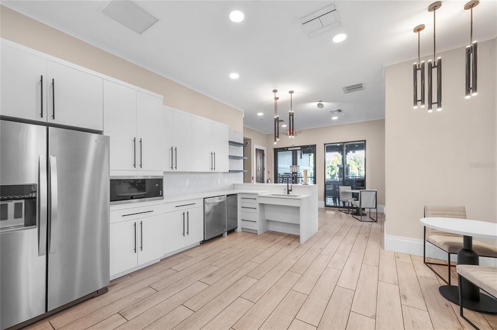 6236 Springmont Loop Palmetto, FL 34221 - Photo 49 of 55 a kitchen with stainless steel appliances a refrigerator sink and stove top oven
