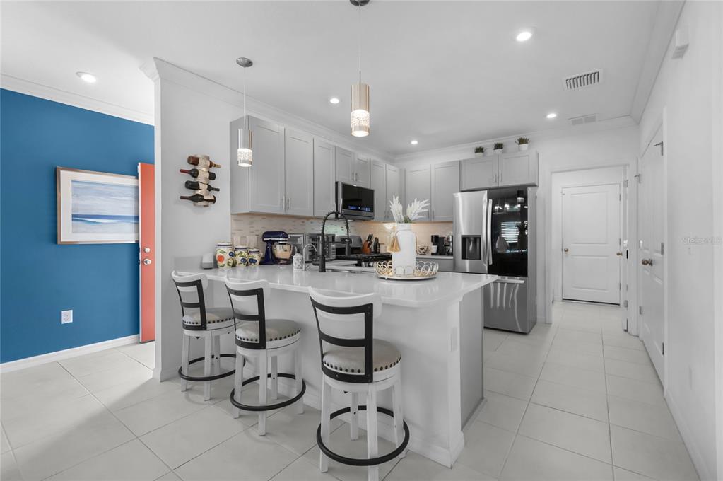 6236 Springmont Loop Palmetto, FL 34221 - Photo 6 of 55 a kitchen with counter top space cabinets and stainless steel appliances