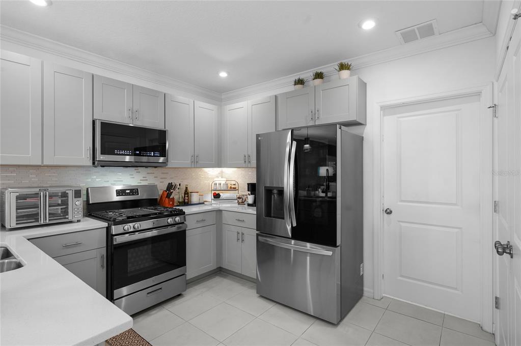 6236 Springmont Loop Palmetto, FL 34221 - Photo 8 of 55 a kitchen with stainless steel appliances a refrigerator stove and microwave
