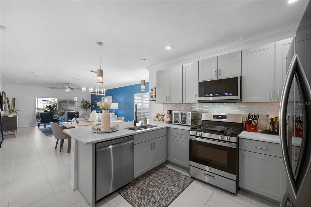 6236 Springmont Loop Palmetto, FL 34221 - Photo 9 of 55 a kitchen with a sink stove and cabinets