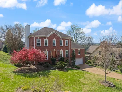 a front view of a house with a yard garage and outdoor seating