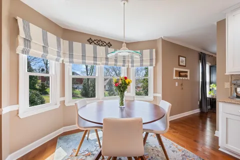 a dining room with furniture and wooden floor