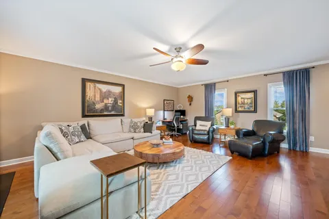 a living room with furniture and a wooden floor
