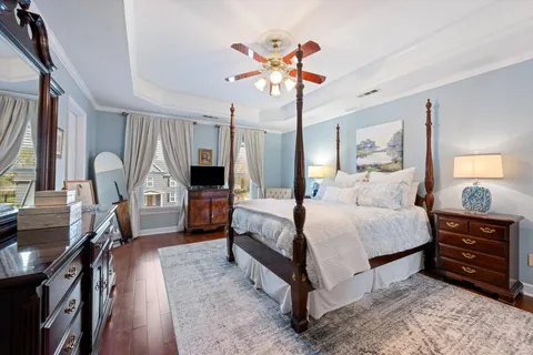 a bedroom with a bed and a chandelier