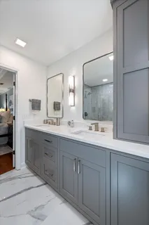 a bathroom with a sink vanity and mirror