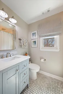 a spacious bathroom with a double vanity sink mirror and toilet