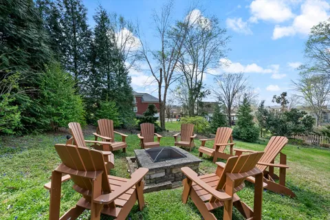 a backyard of a house with table and chairs