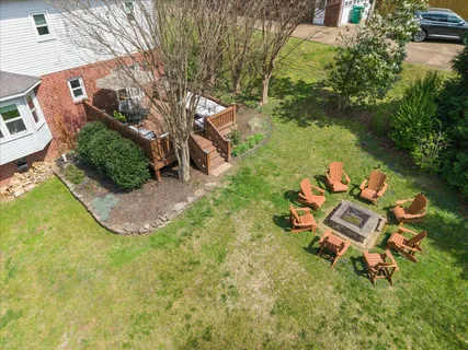 an aerial view of a house with garden space and street view