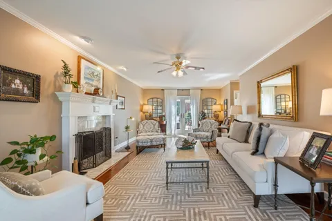 a living room with furniture fireplace and a window