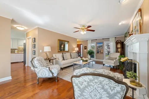 a living room with furniture and a chandelier