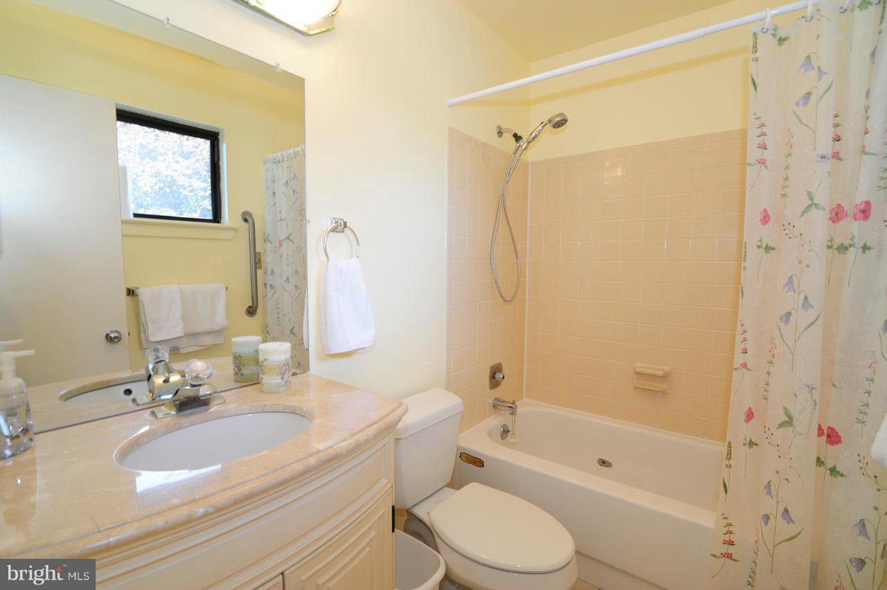 2012 Lakewinds Drive Reston, VA 20191 - Photo 18 of 26 a bathroom with a granite countertop sink a toilet and shower