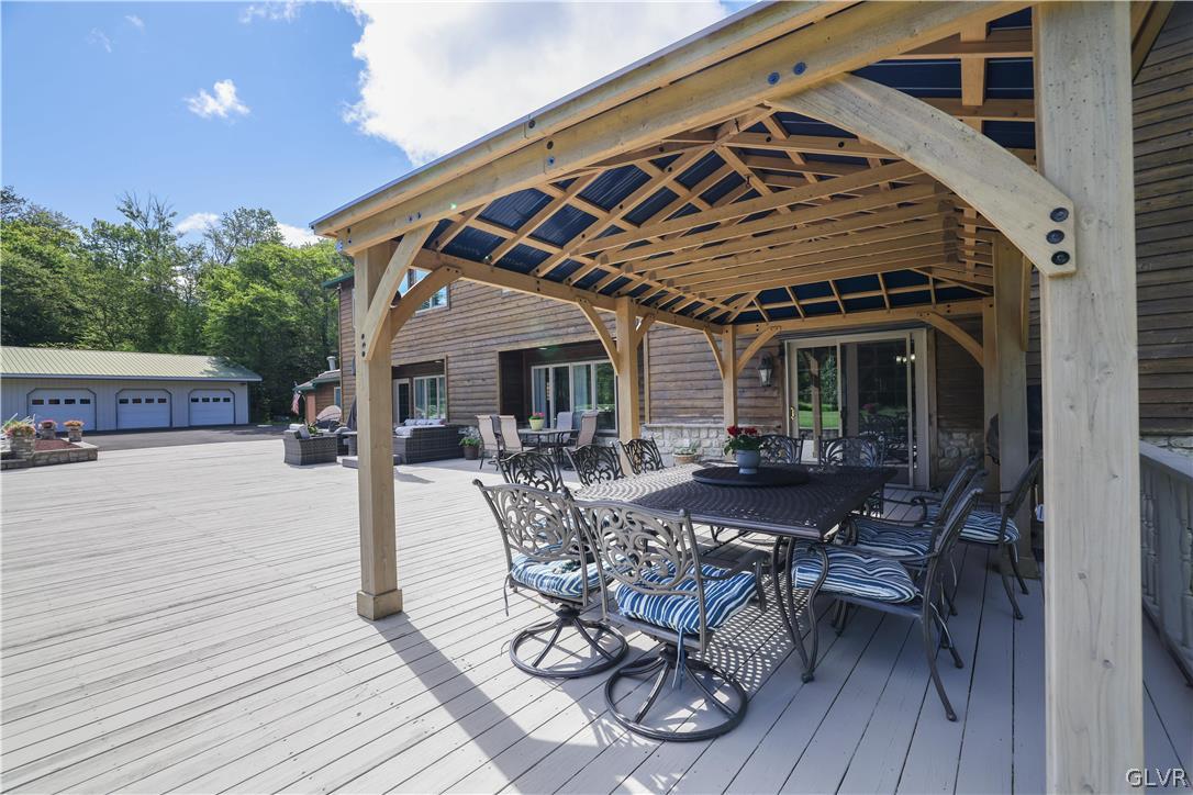 2285 Green Road Tobyhanna, PA 18466 - Photo 34 of 42 a view of a patio with table and chairs with wooden floor and fence