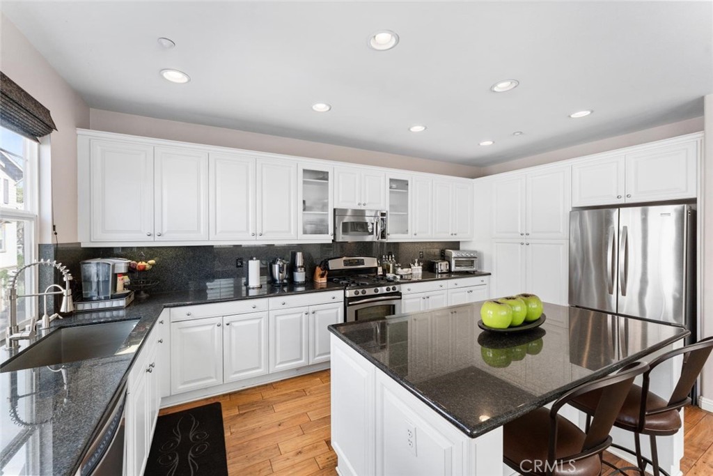 22 Arlington Street Ladera Ranch, CA 92694 - Photo 24 of 51 a kitchen with a sink a counter top space stainless steel appliances and cabinets