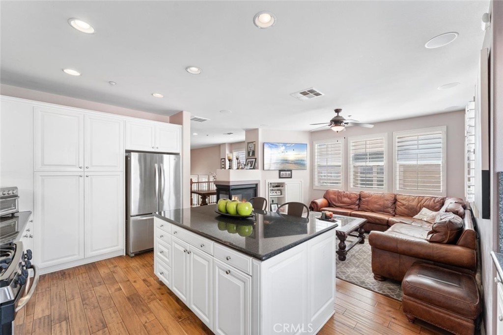 22 Arlington Street Ladera Ranch, CA 92694 - Photo 25 of 51 a kitchen with stainless steel appliances granite countertop a sink and a refrigerator