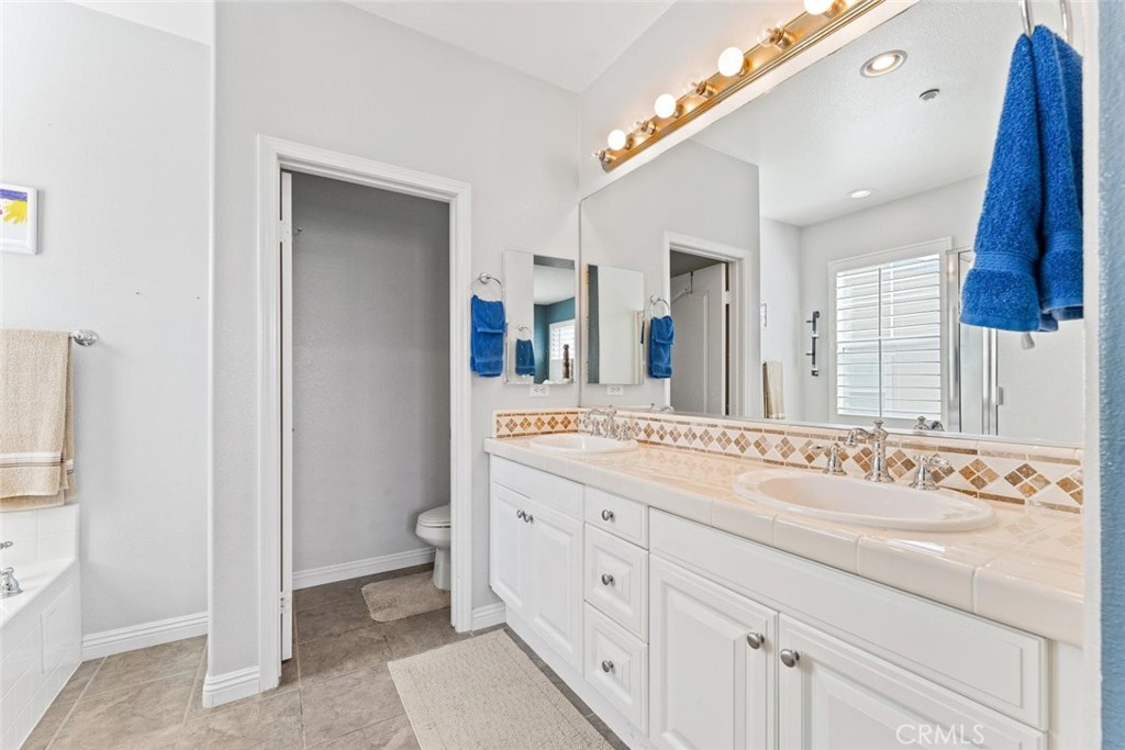22 Arlington Street Ladera Ranch, CA 92694 - Photo 29 of 51 a spacious bathroom with a double vanity sink and a mirror