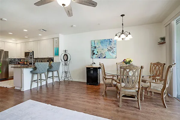 a kitchen with stainless steel appliances granite countertop a refrigerator stove and sink