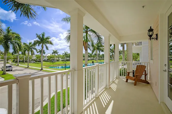 a view of a porch with furniture and floor to ceiling window