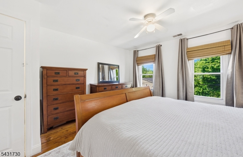 105 Main Street Lebanon, NJ 08833 - Photo 14 of 25 a bedroom with a large bed and a dresser