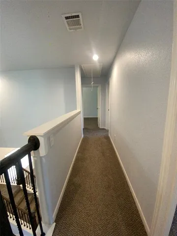 a view of staircase with white walls