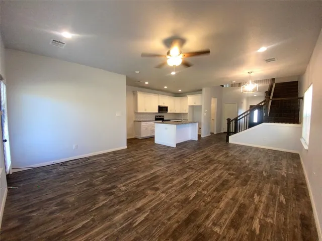 a view of a kitchen with a sink and a refrigerator