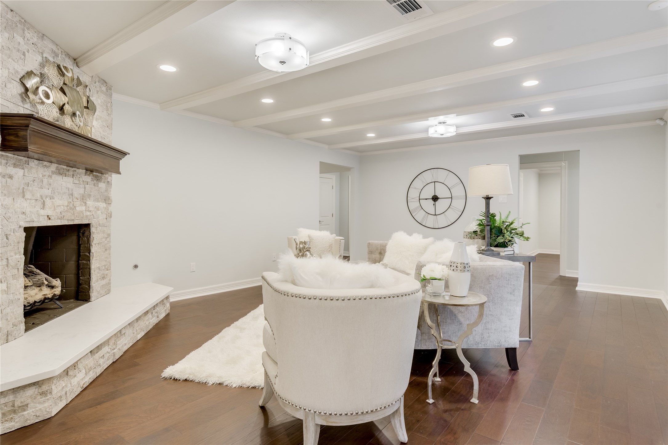 1010 Thornton Road Houston, TX 77018 - Photo 5 of 27 This living room features a stone fireplace with gas logs and engineered wood flooring. The space is bright with recessed lighting.