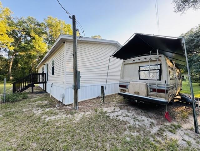 11817 Southwest 58th Street Webster, FL 33597 - Photo 31 of 46 a view of a house with a yard