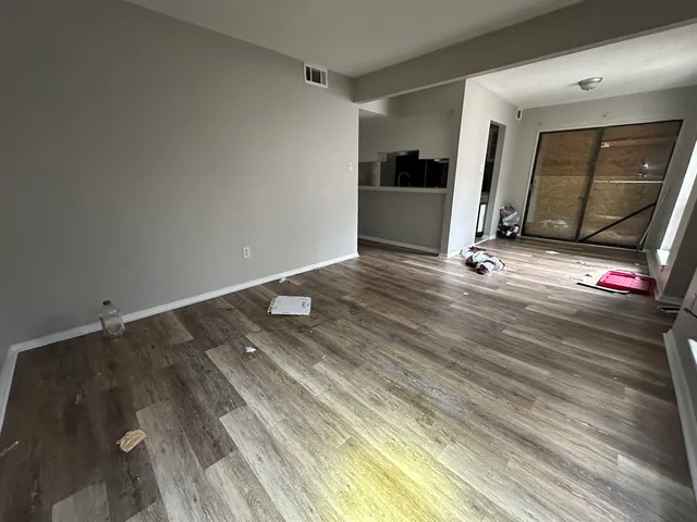 a view of a room with wooden floor