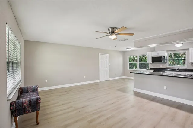 a view of workspace with furniture and ceiling fan