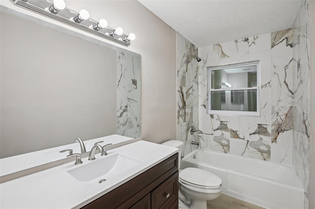 204 East Shell Point Road Ruskin, FL 33570 - Photo 15 of 48 a bathroom with a sink a toilet and shower