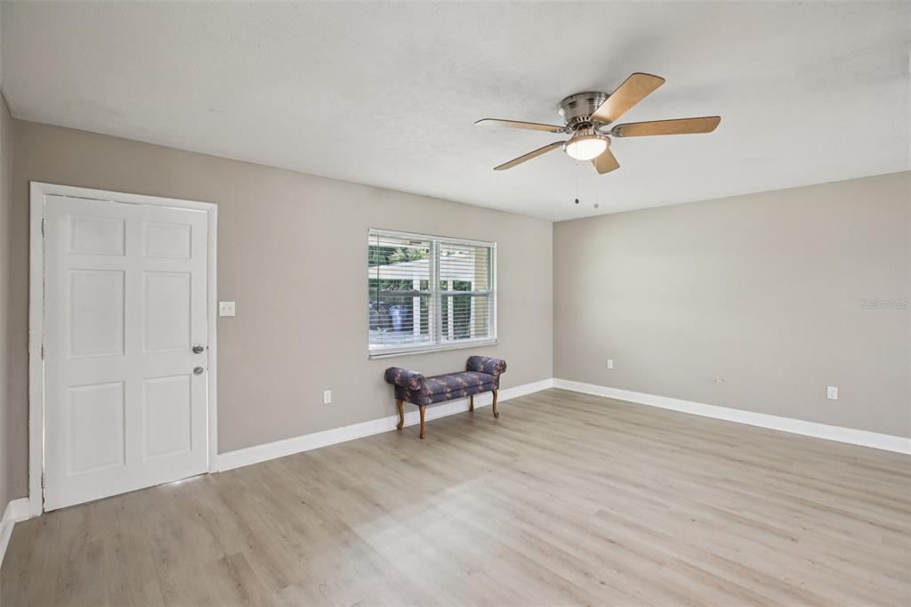204 East Shell Point Road Ruskin, FL 33570 - Photo 23 of 48 a view of an empty room with a window and wooden floor